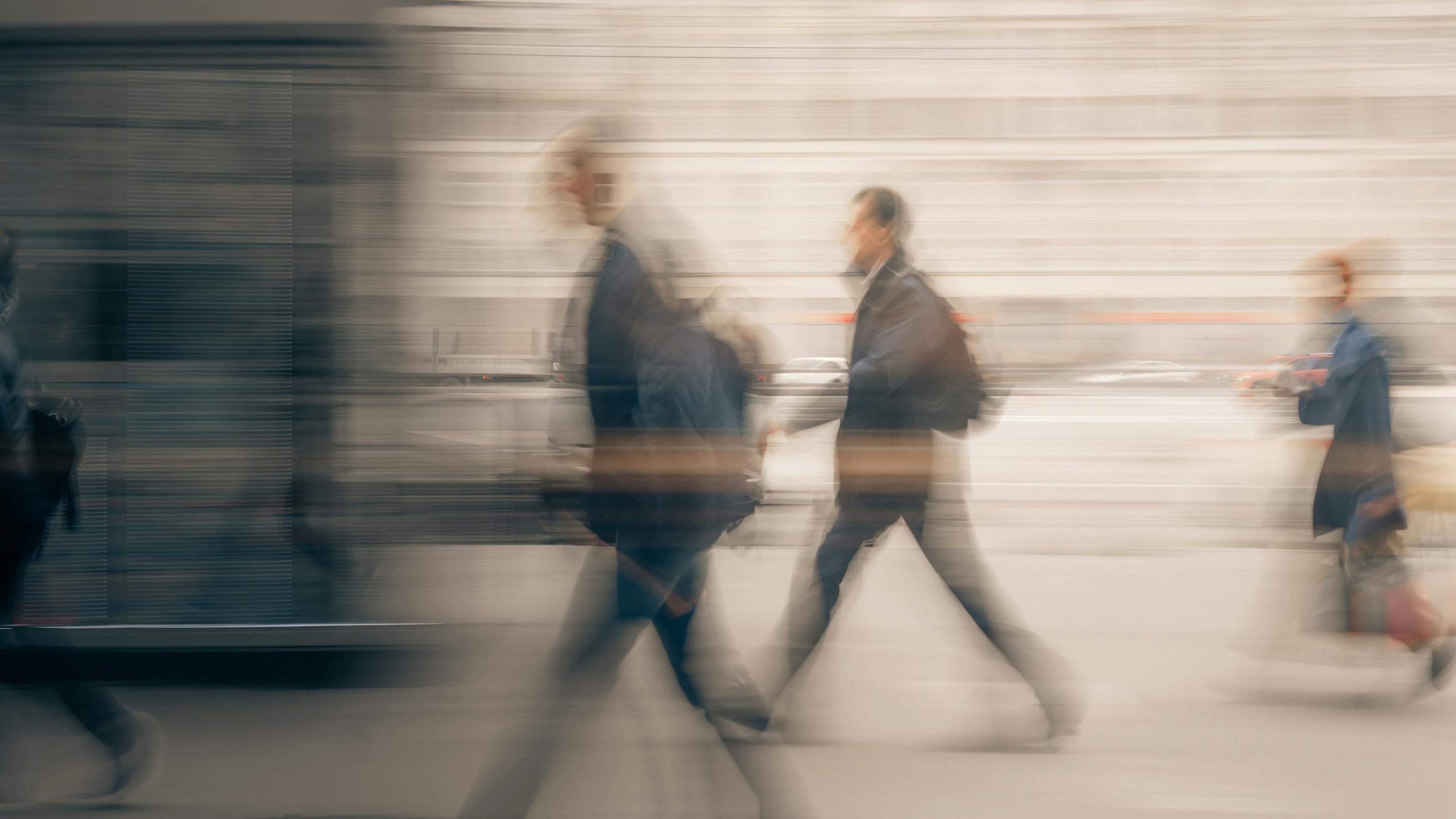 Blurred image of people walking quickly