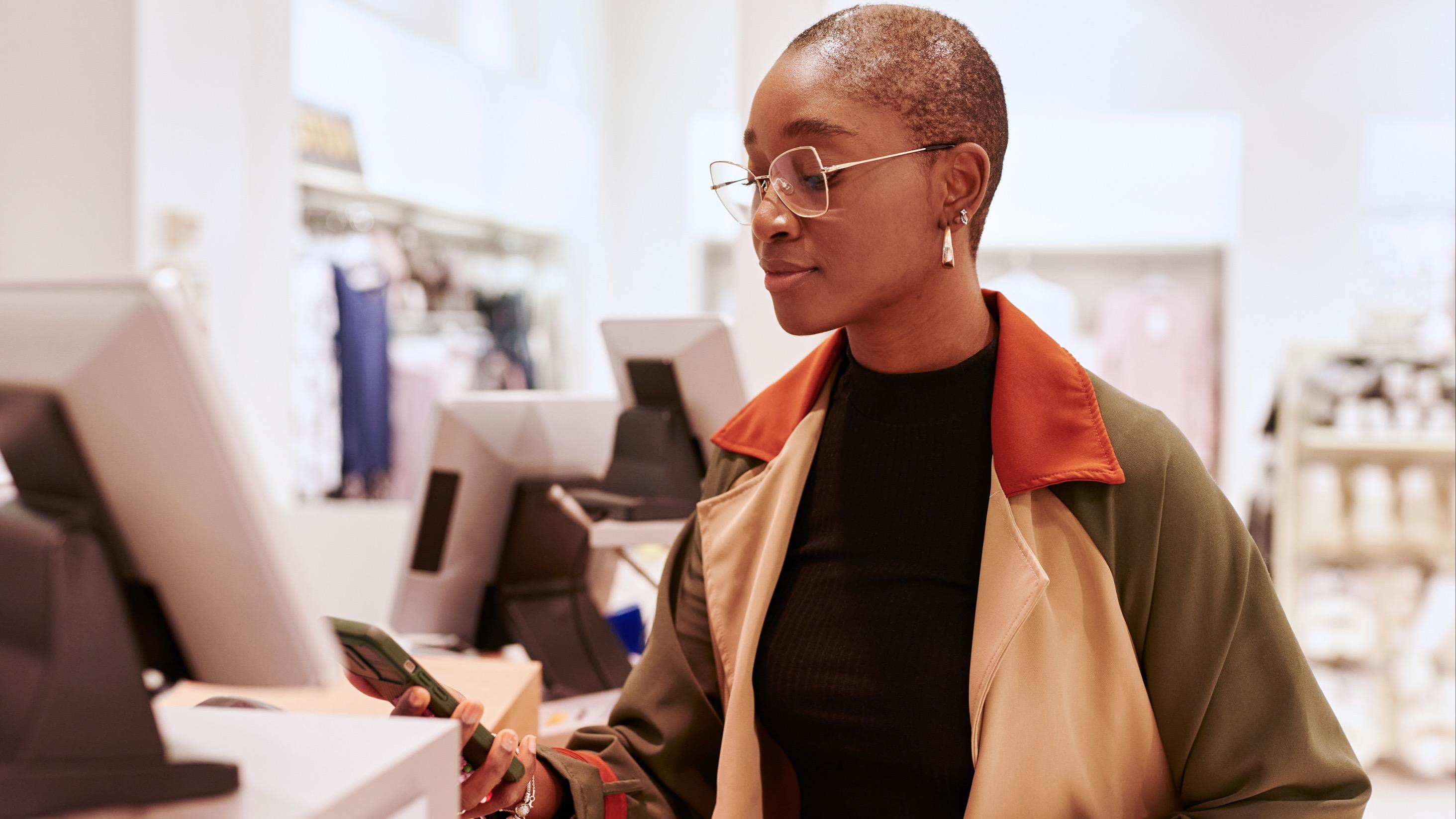 Woman looking at her phone in a store