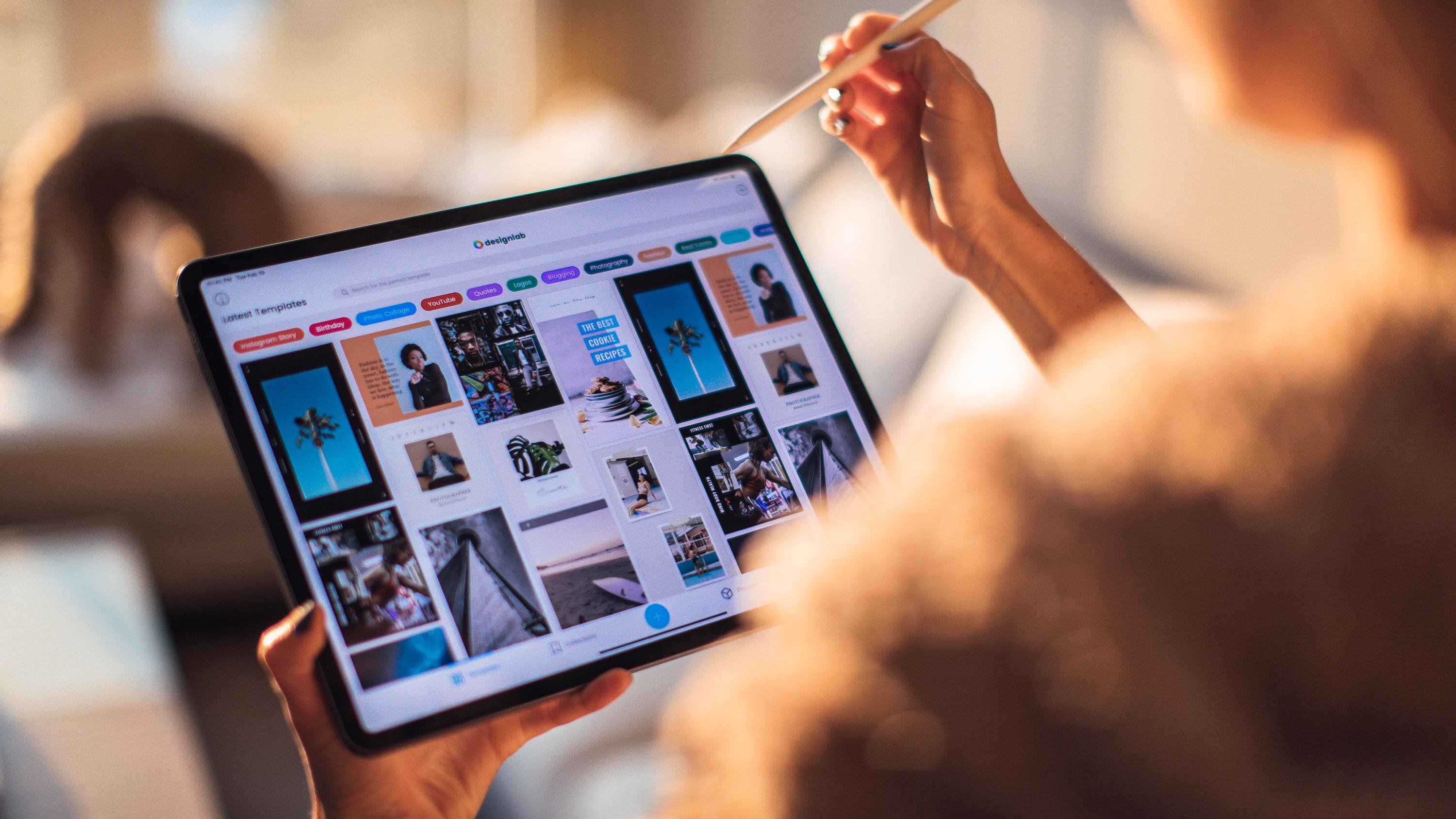 Person using a stylus to browse a website on a tablet