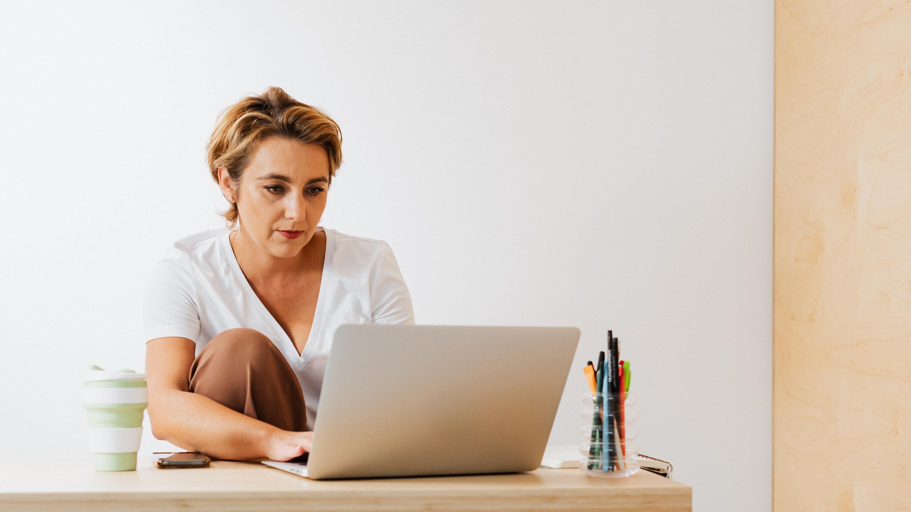 Woman sitting at a desk using a laptop