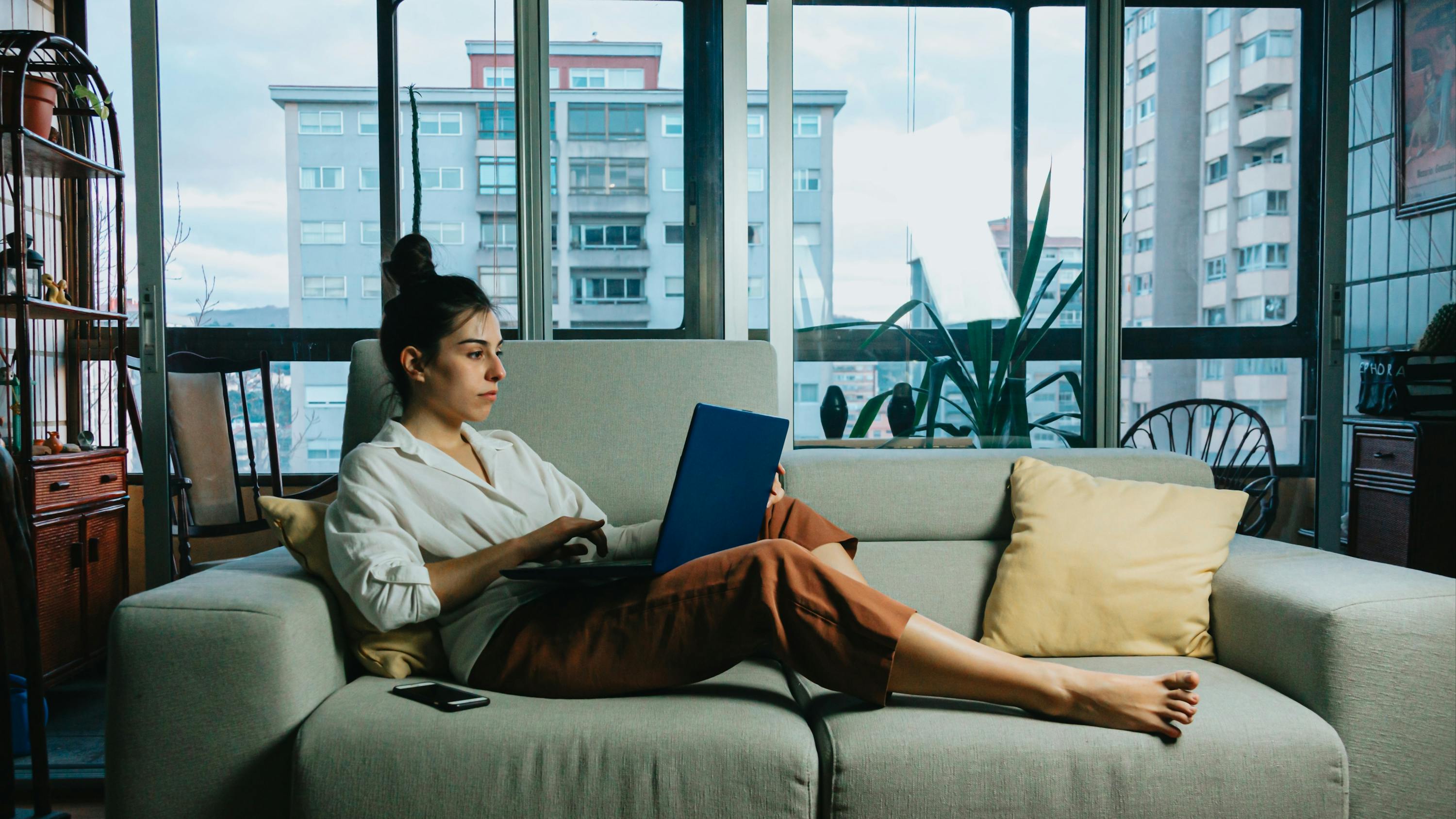 Woman sitting on a couch using her laptop