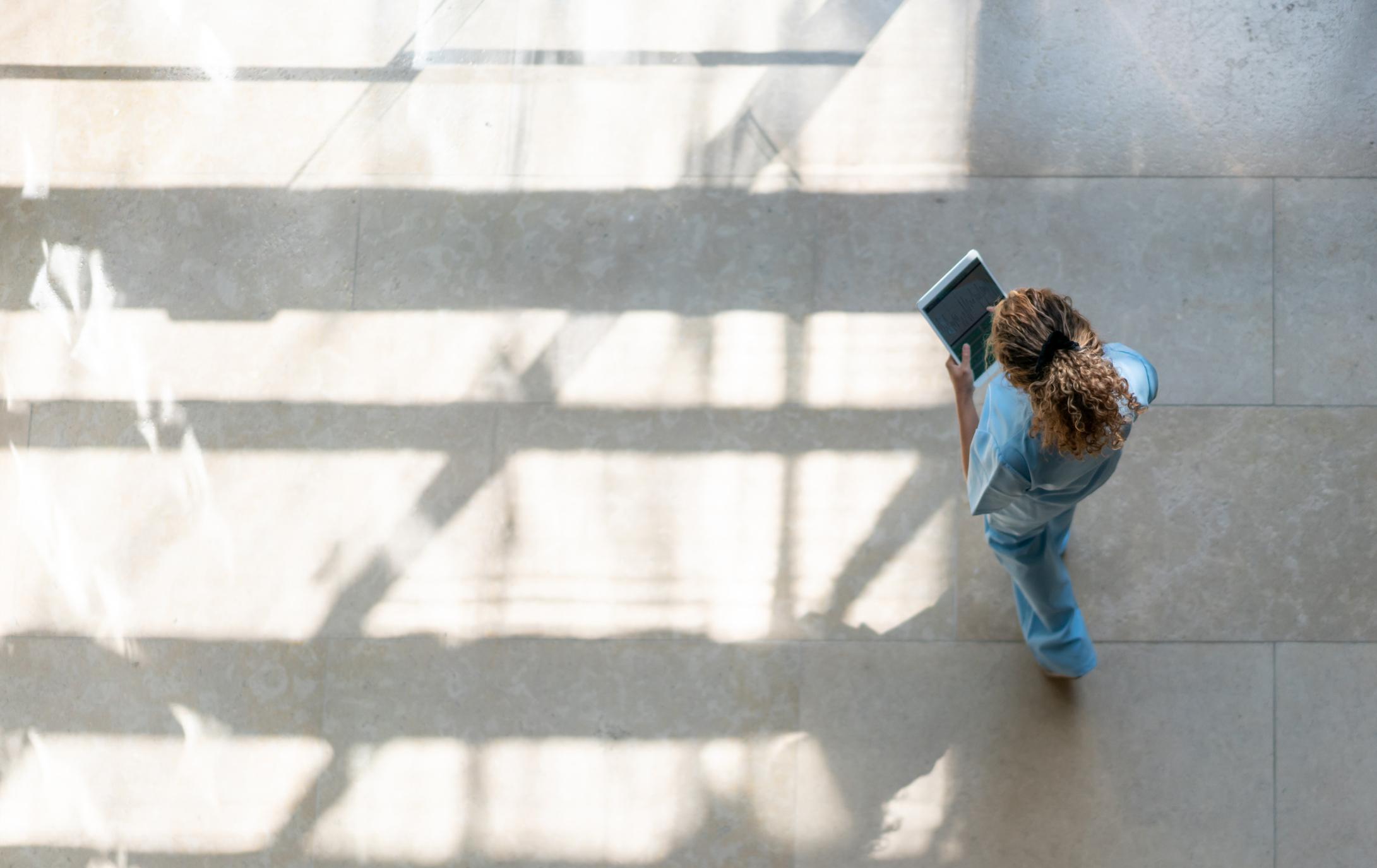 Birds eye view of a healthcare worker walking through a hallway