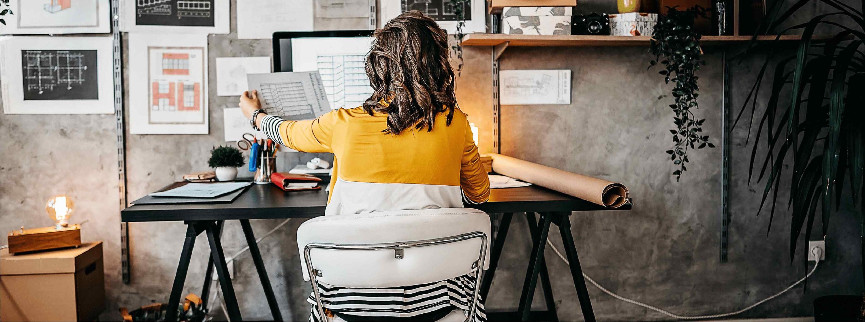 A woman sitting in a chair at a desk.