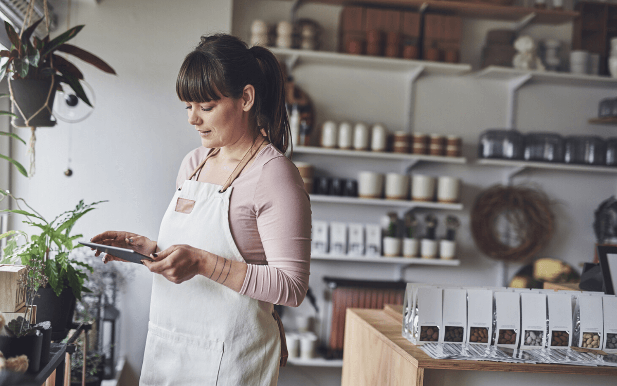 A woman wearing an apron in a store.