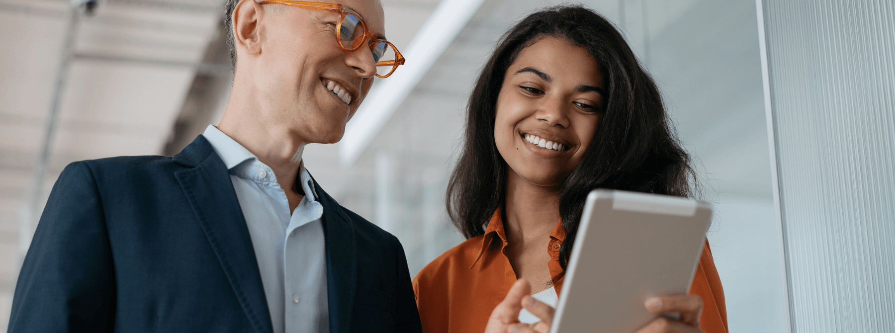 A man and woman smiling. An example of employee experience.